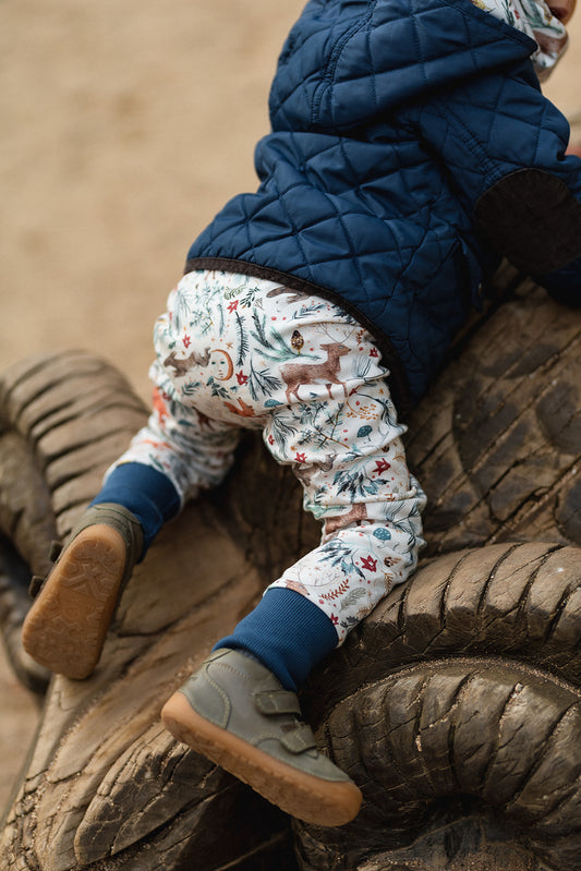 Baby wearing handmade leggings sewn from Chandler pattern - beginner-friendly sewing project
